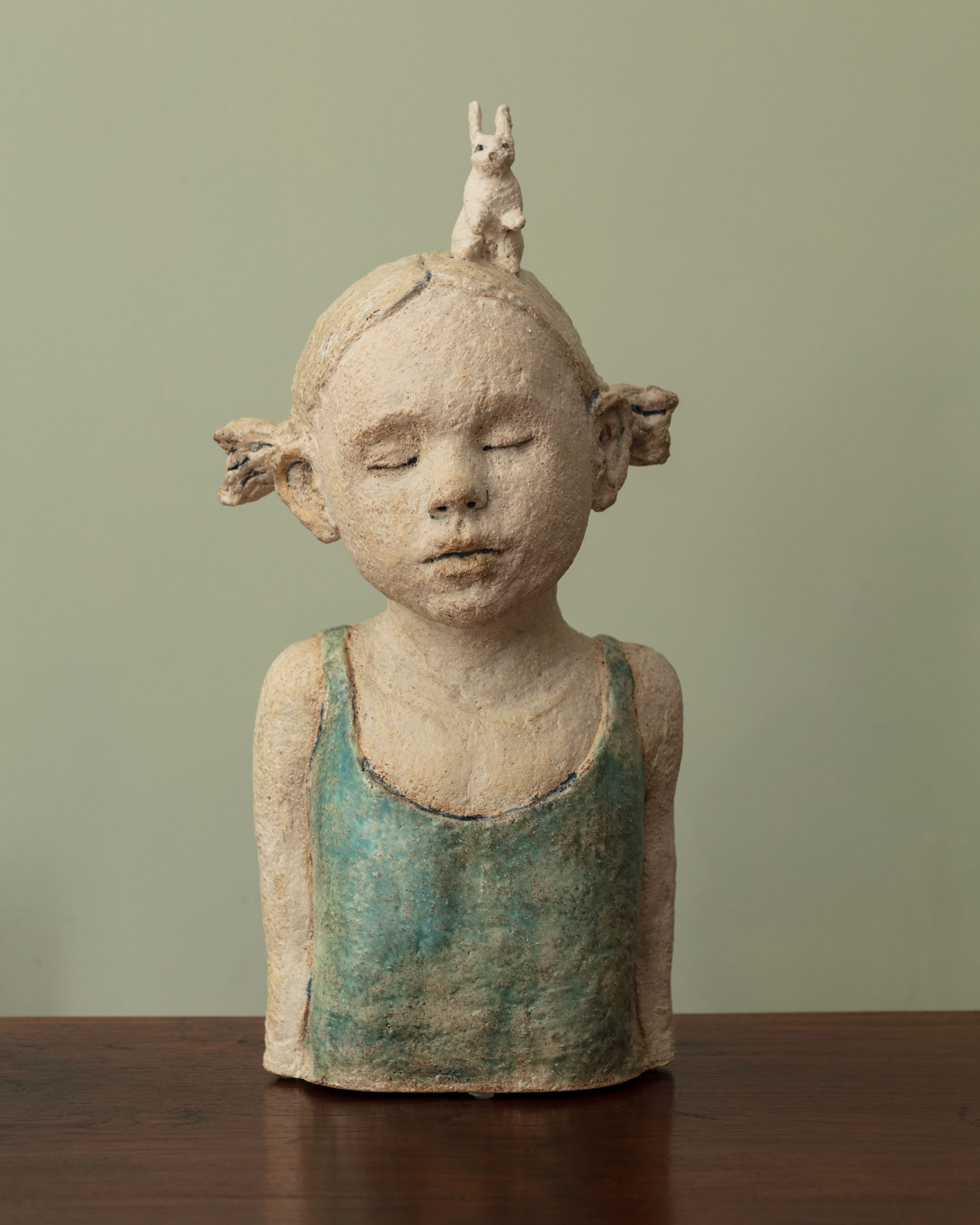 clay sculpture of girl with hare